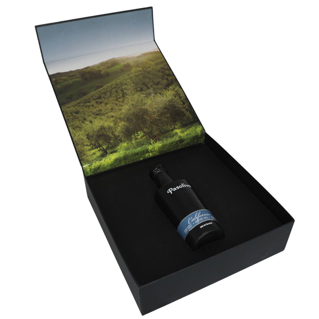 Premium Pasolivo products packaged in beautiful black box with green olive orchard imagery.